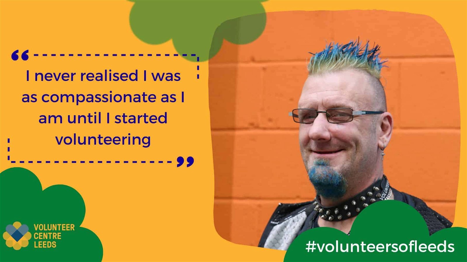 A man with blue hair stands in front of an orange wall. His name is Leroy and he volunteers for Battle Scars